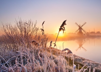 Thurne Drainage Mill at sunrise following an overnight winter hoarfrost on the Norfolk Broads