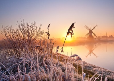 Thurne Drainage Mill at sunrise following an overnight winter hoarfrost on the Norfolk Broads