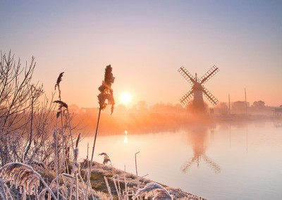 Thurne Drainage Mill at sunrise following an overnight winter hoarfrost on the Norfolk Broads