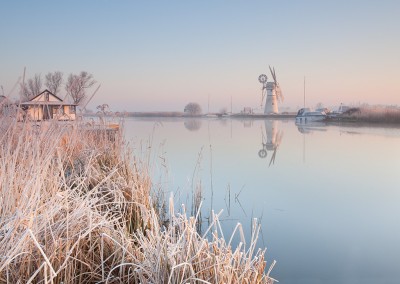 Thurne Mill reflecting in the River Thurne following an overnight winter frost