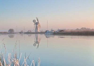 Thurne Mill reflecting in the River Thurne following an overnight winter frost