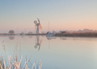 Thurne Mill reflecting in the River Thurne following an overnight winter frost
