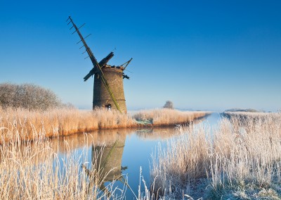 The derelict mill of Brograve on the Norfolk Broads following an overnight winter hoarfrost