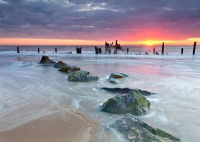 Happisburgh beach and the derelict sea defences captured at sunrise on the Nofolk Coast