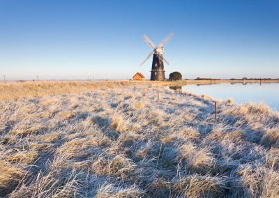 The remote Halvergate Marshes at Berney Arms Mill on the Norfolk Broads. Captured following an overnight hoarfrost.