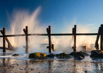 Waves crashing against sea defences at Happisburgh on the Norfolk Coast