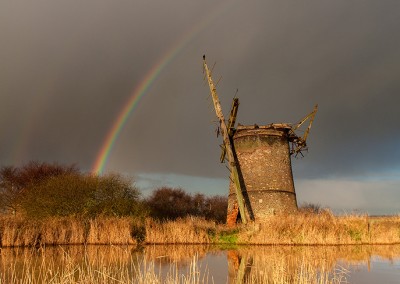 Rainbow over the derelict Brograve drainage mill on the Norfolk Broads