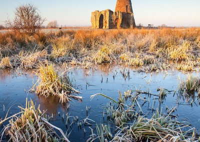 St Benet's Abbey on a frosty morning on the Norfolk Broads. The frozen water in the foreground is from the medieval fish ponds that would have kept the monks well fed.