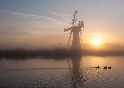 Thurne Mill at sunrise on the River Thurne, Norfolk Broads