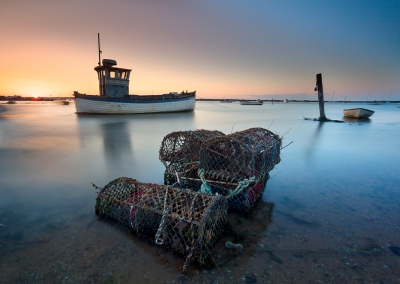 Brancaster Staithe fishing boats at sunset on the North norfolk Coast