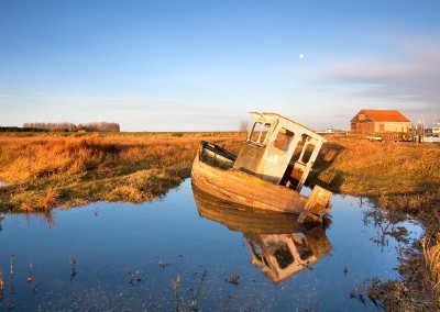 Derelict boat at Thornham Harbour at first light