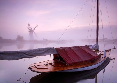 Sailing boat and windpump on the Norfolk Broads