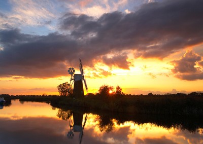 Turf Fen Windmill on the Norfolk Broads reflecting in the River Ant at sunset