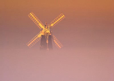 Berney Arms windmill on the Norfolk Broads rising from the Mist on a cold Decembers morning